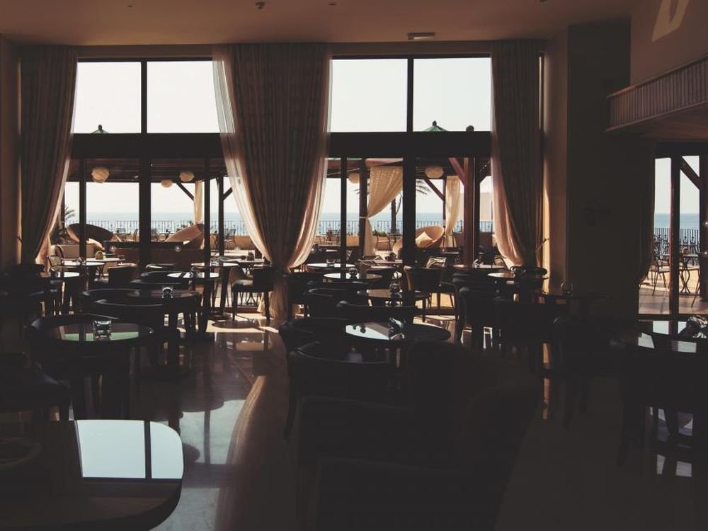 Set restaurant table in a dimly lit dining room in the evening